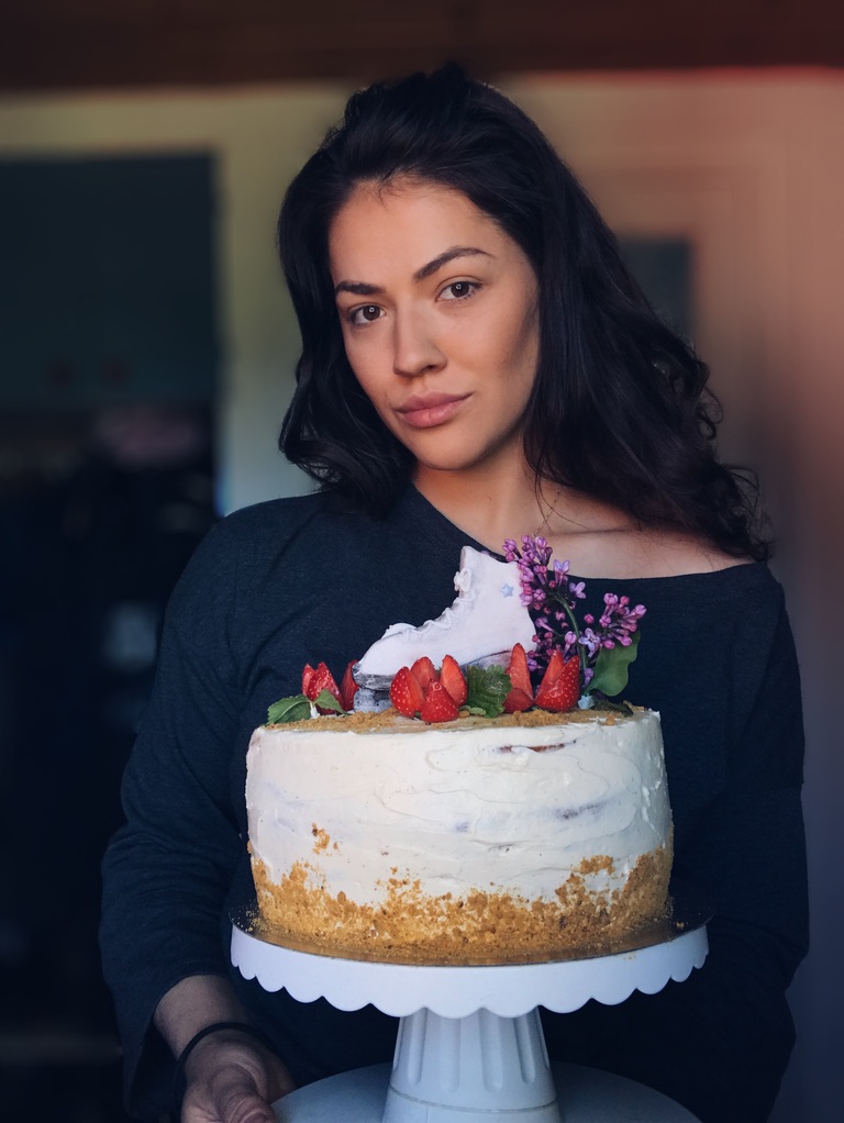 a woman holding a cake
