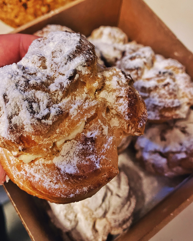 a hand holding a pastry