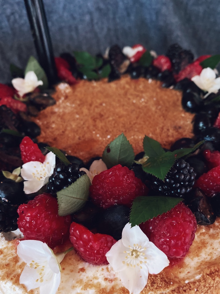 a cake with berries and leaves