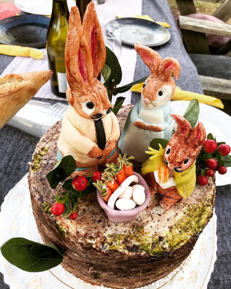 a cake with bunny figurines on top